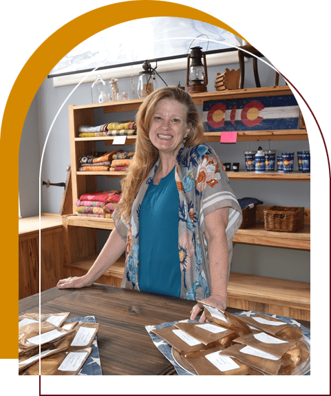 A woman standing in front of some food.