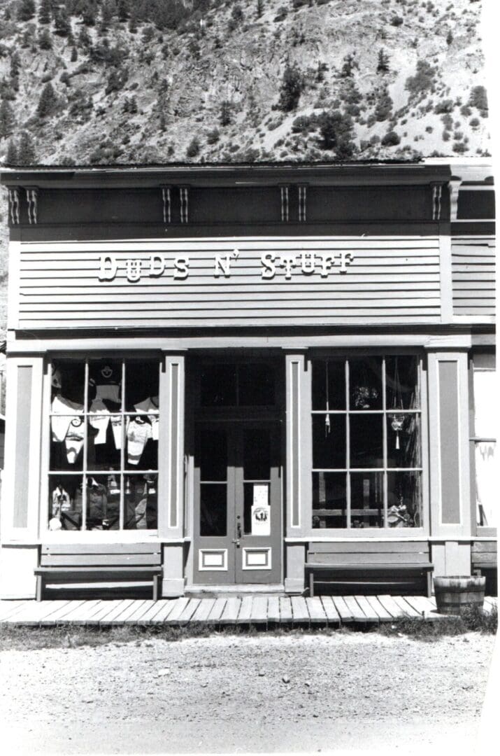 A black and white photo of the front entrance to a store.