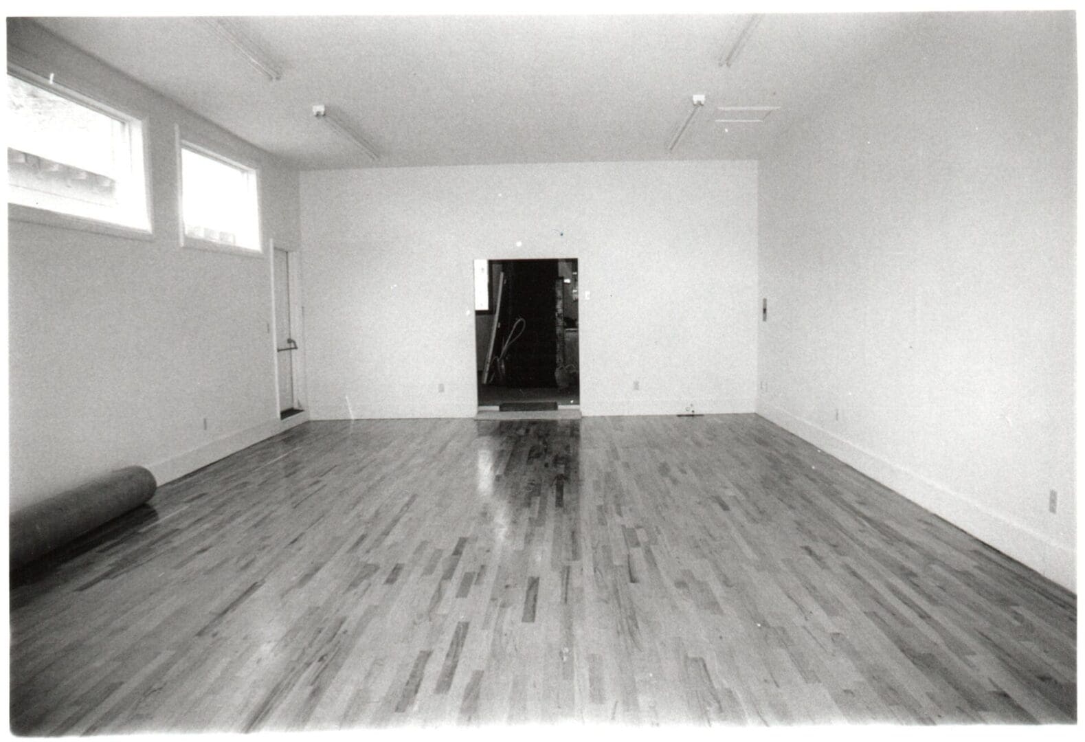 A room with wood floors and white walls.